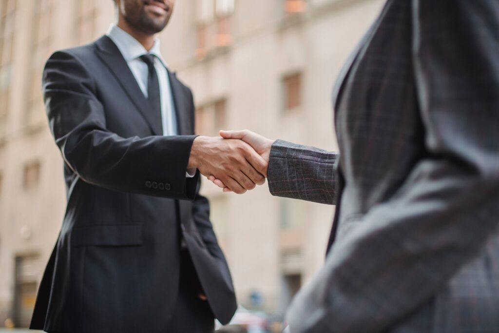Sales professional shaking hands with a customer